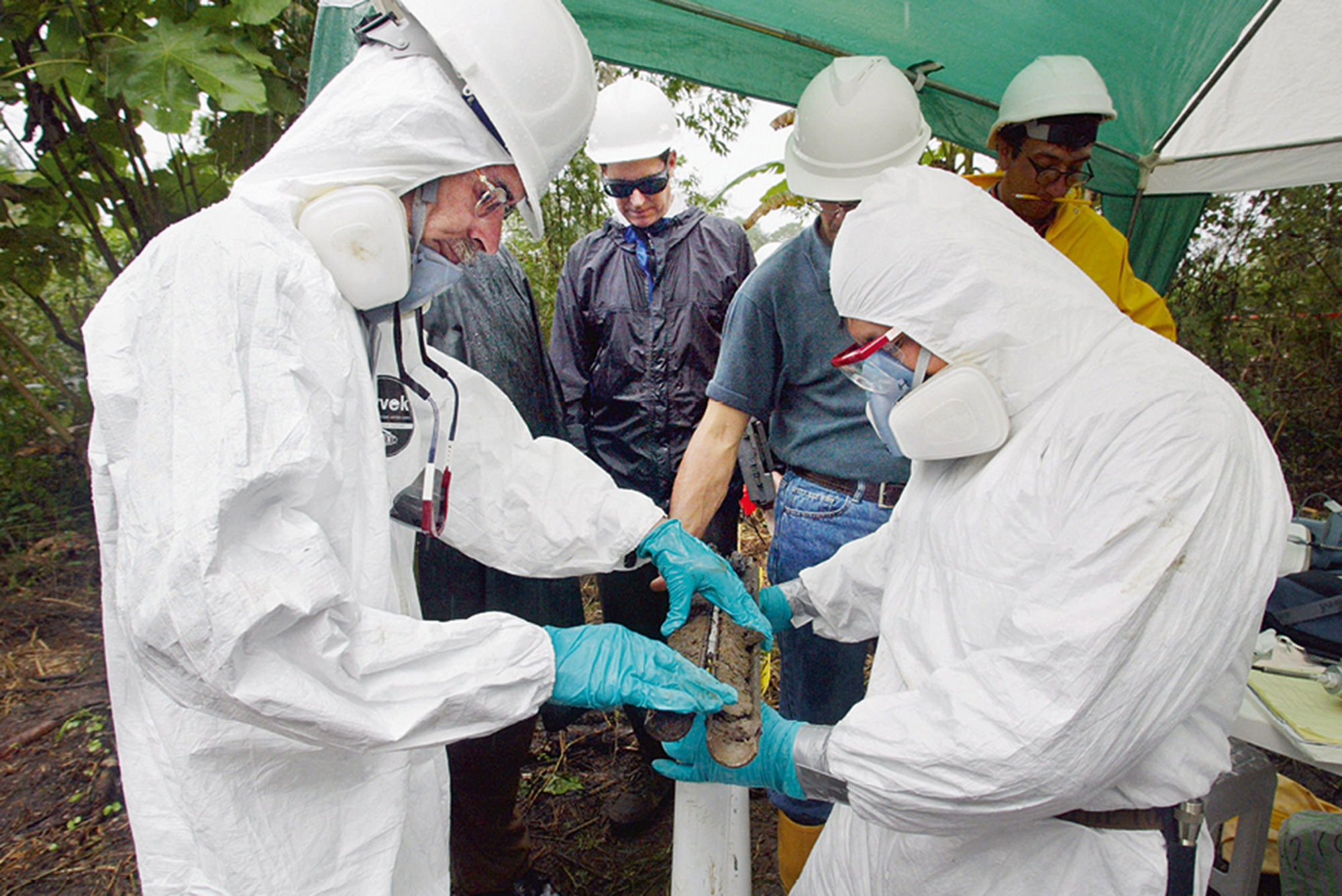 Lou Dematteis’s photograph of Chevron technical expert John Connors overseeing technicians in hazmat suits checking a soil sample for evidence of crude oil during judicial inspections at an old Texaco well site near the town of Sacha.
