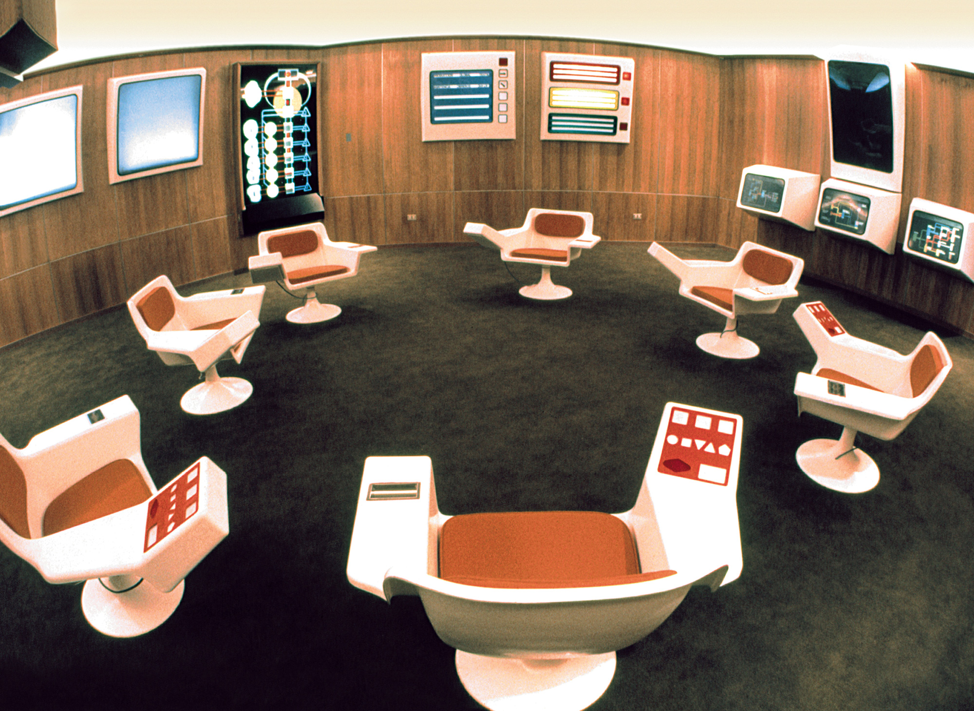 “A photograph of display screens in the Cybersyn operations room.”