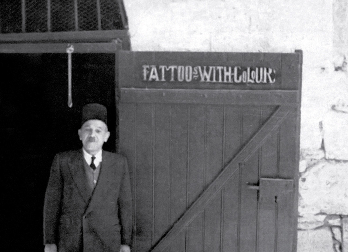 A circa nineteen fifty photograph of Jacob Razzouk outside his shop on Christian Street in Jerusalem.