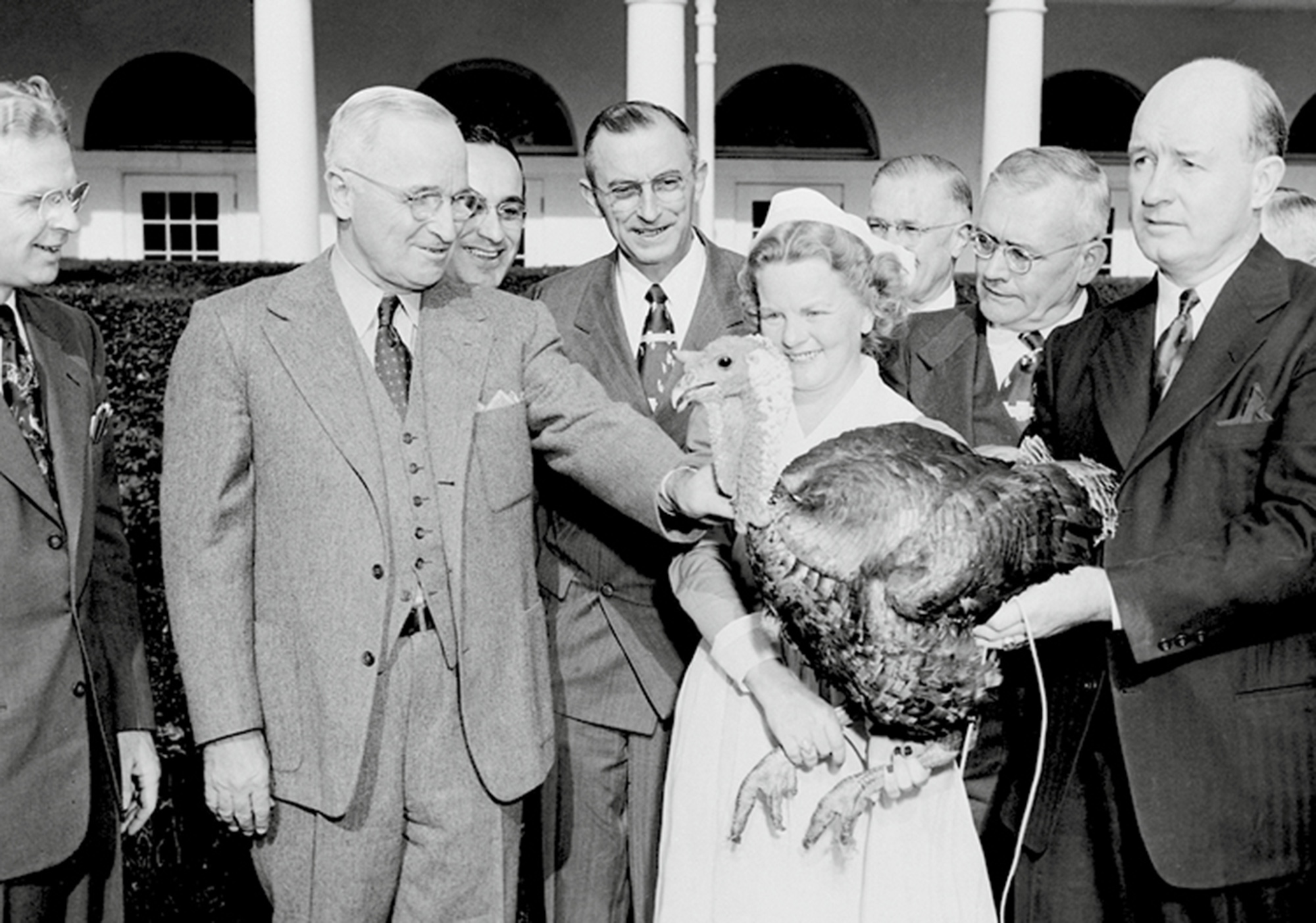 A photograph of President Truman receiving a turkey as a gift. The bird was not pardoned, despite rumors to the contrary, and was most likely eaten at the presidential table.