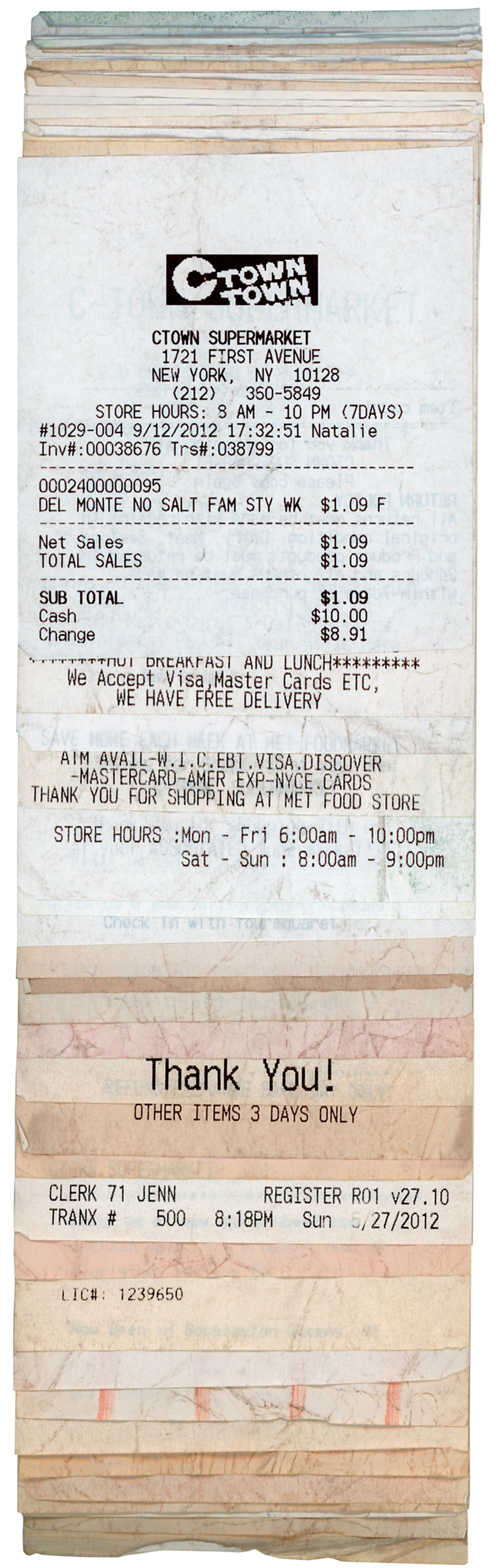 An artwork consisting of a stack of receipts in different colors, topped by a receipt from C Town Supermarket. 
