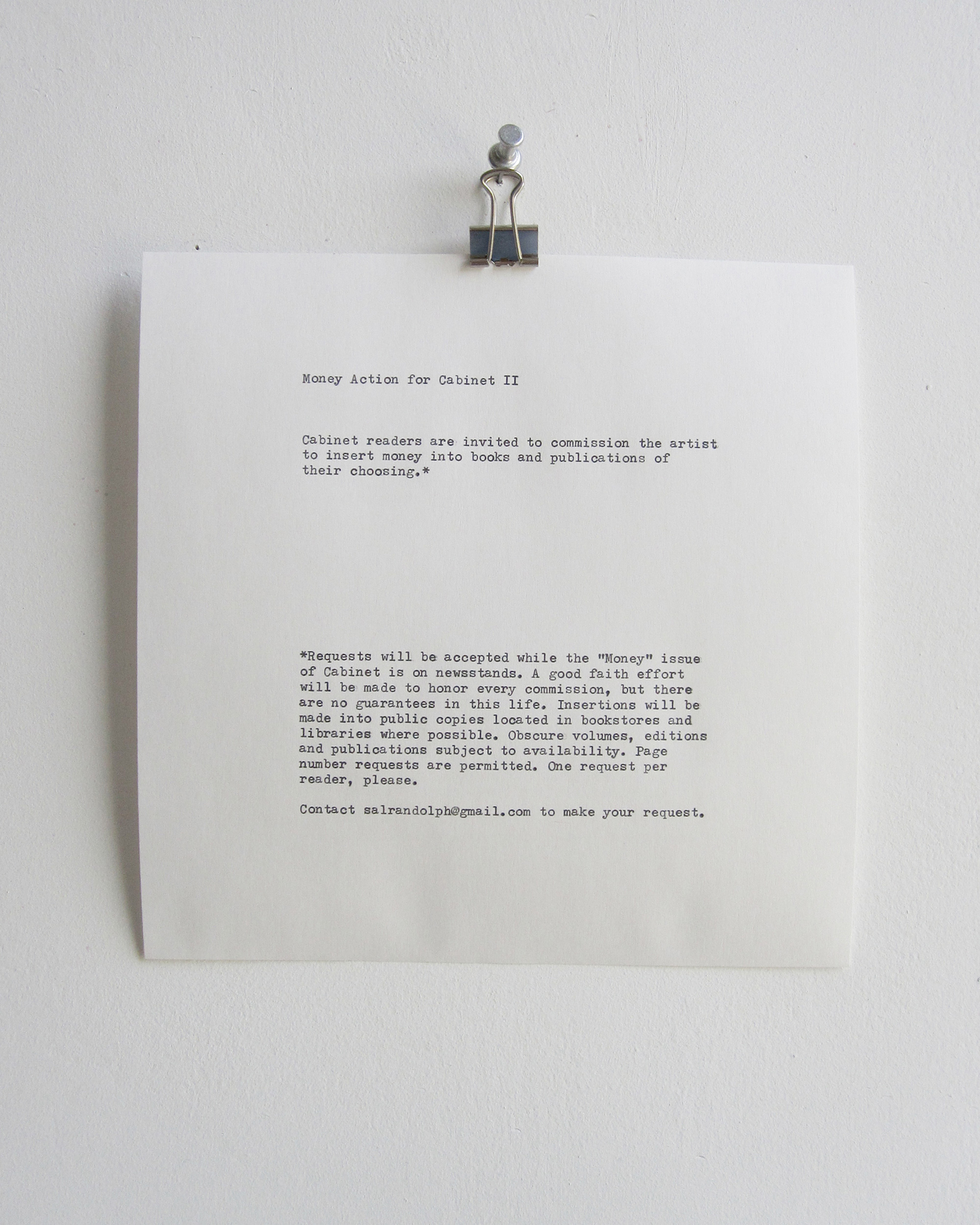 A photograph of an announcement fixed to a wall, part of Sal Randolph’s piece titled ”Money Action for Cabinet two.” It reads “Cabinet readers are invited to commission the artist to insert money into books and publications of their choosing.” 