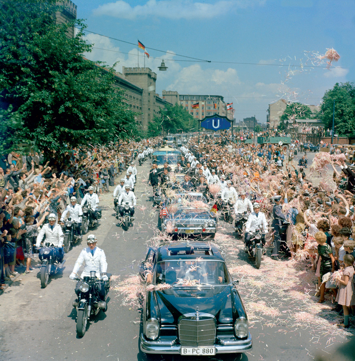 A photograph of John F. Kennedy’s motorcade showered with confetti in West Berlin on the 26th of June, nineteen sixty-three. 