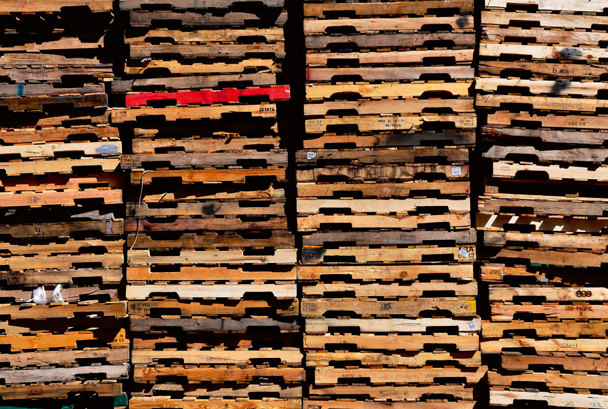 A photograph of piles of pallets at Pallets Unlimited, New Hyde Park, Long Island.