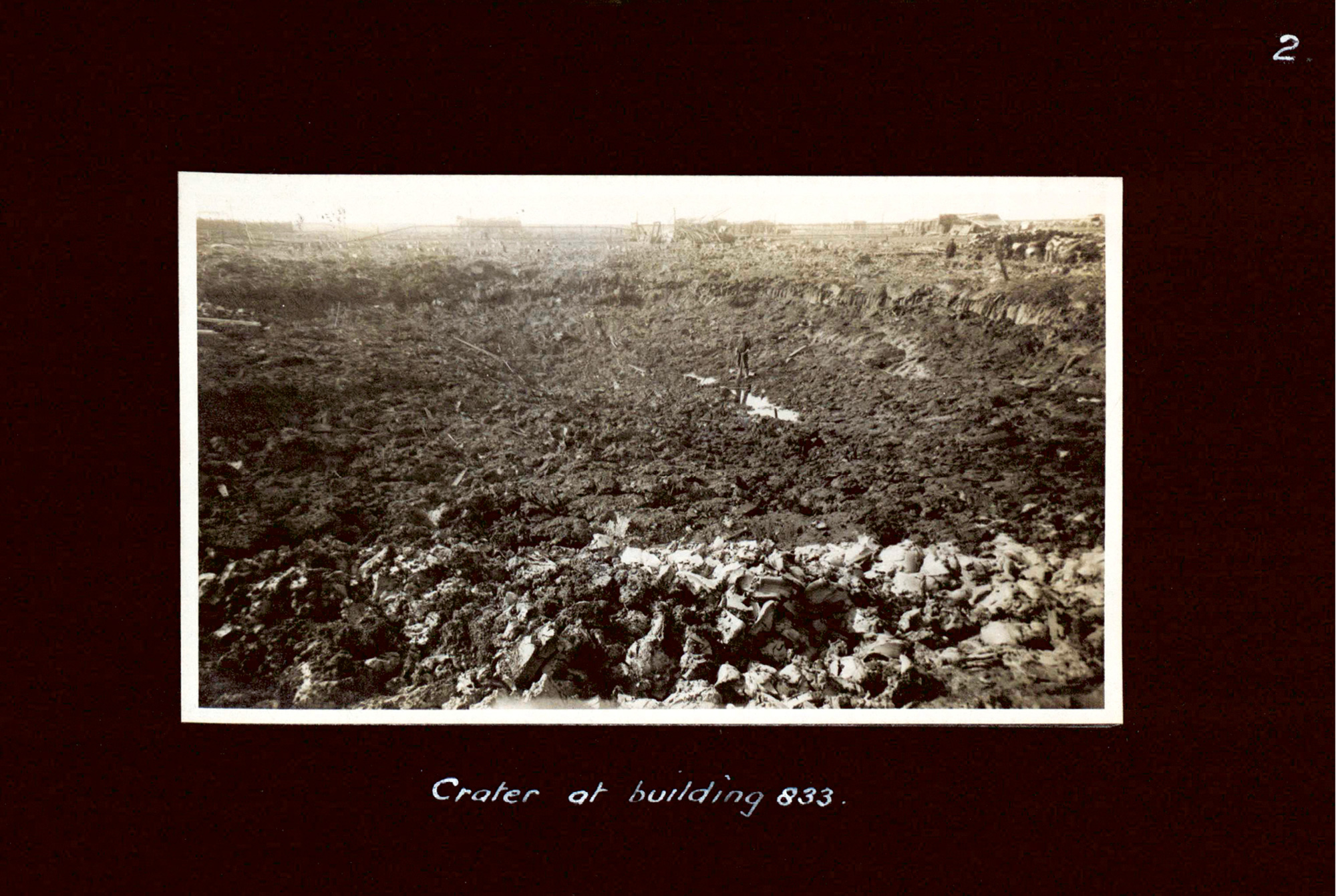 A photograph of the crater of Building 833 from an album collected for Major Cooper-Key’s report on “Accident Number 110, nineteen sixteen: Explosion of Tri-nitro-toluol and Ammonium Nitrate at Uplees Marches — Faversham.”