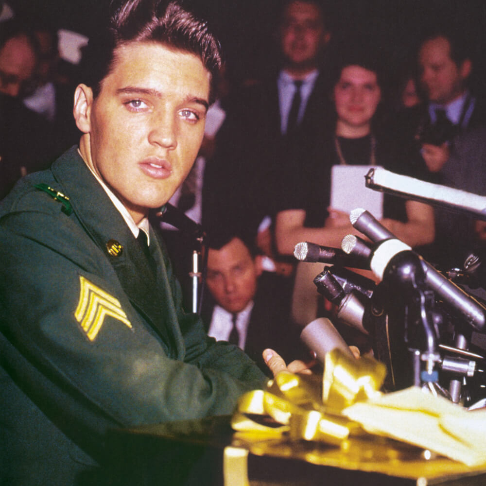 A photograph of Elvis Presley wearing army green at a press conference at Fort Dix, New Jersey, in March nineteen sixty, two days before being discharged from the US Army.