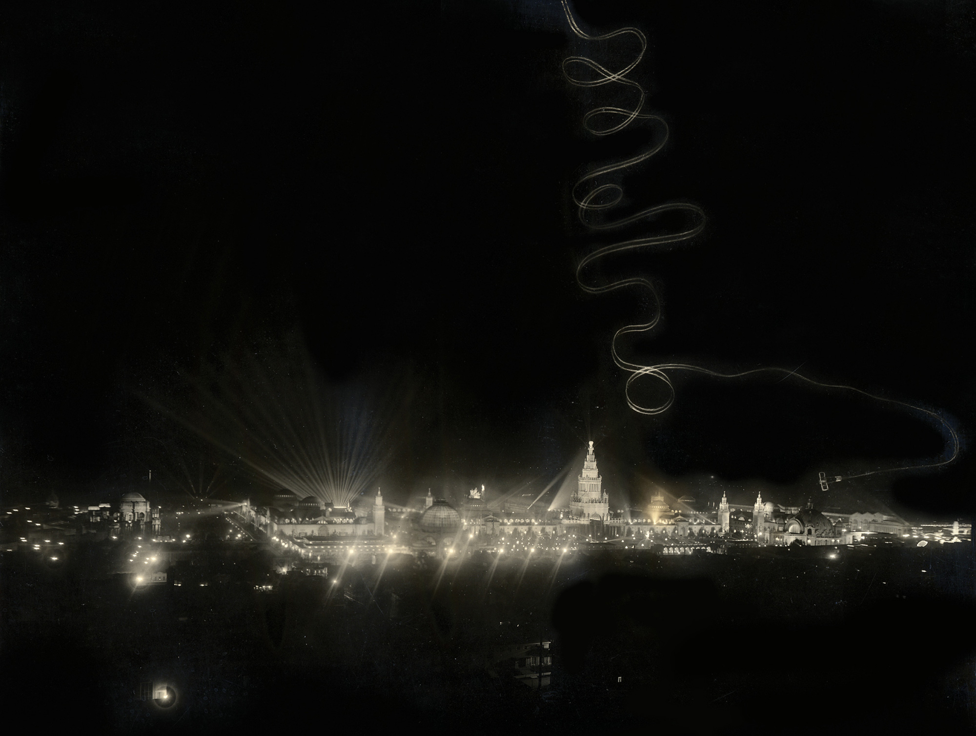 A photograph of skywriting from an Art Smith performance on the final evening of the Panama-Pacific International Exposition. Like the inscription made by Smith on August eighth at the end of his first stint flying for the exposition, his looping flight path on its closing night has also been interpreted as a written goodbye note. 