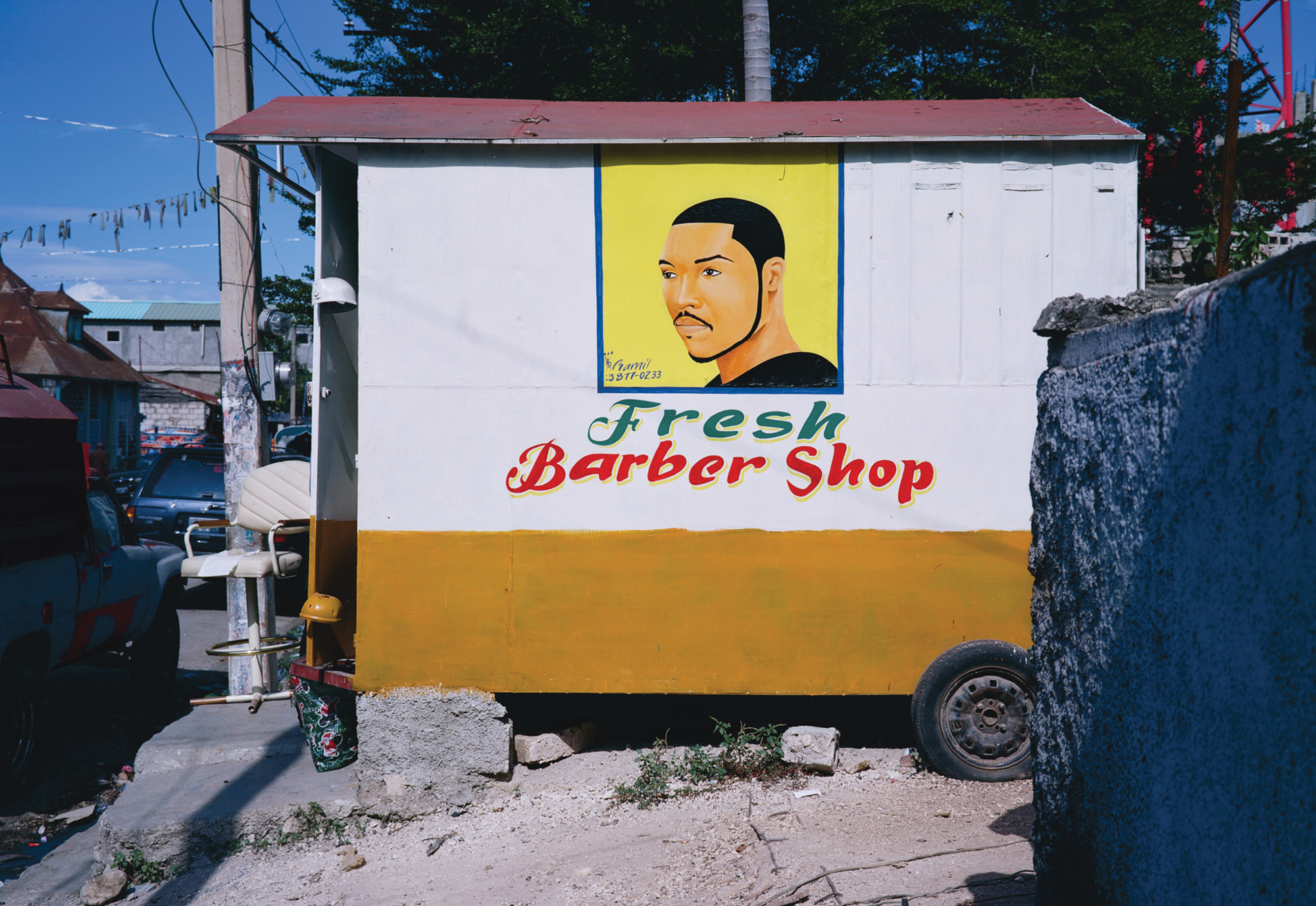 A photograph of the roadside Fresh Barber Shop in Port-au-Prince.