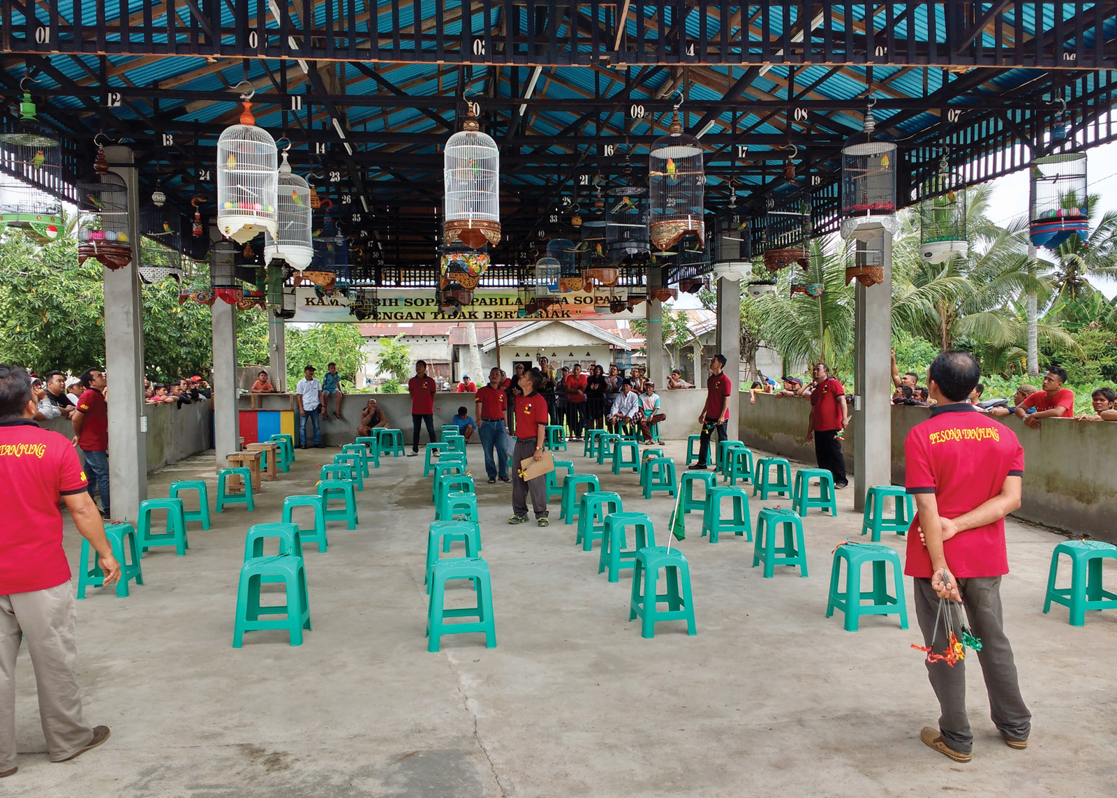 A photograph of a group of spectators at a songbird competition in Pontianak, West Kalimantan. Such contests are common across much of Indonesia. 