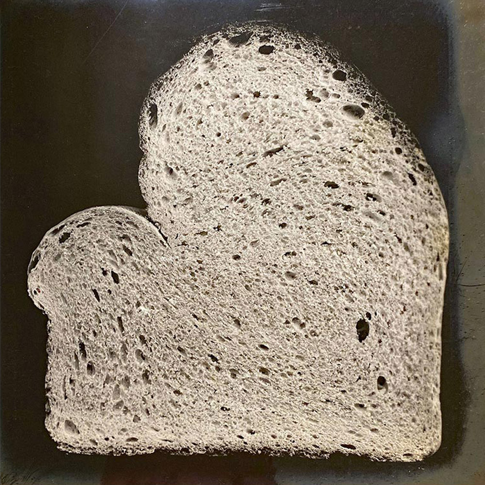A photograph from Owen Simmons’s “The Book of Bread” depicting, according to the original caption, a section of “a typical French loaf from Scotland baked in a shallow pan.”