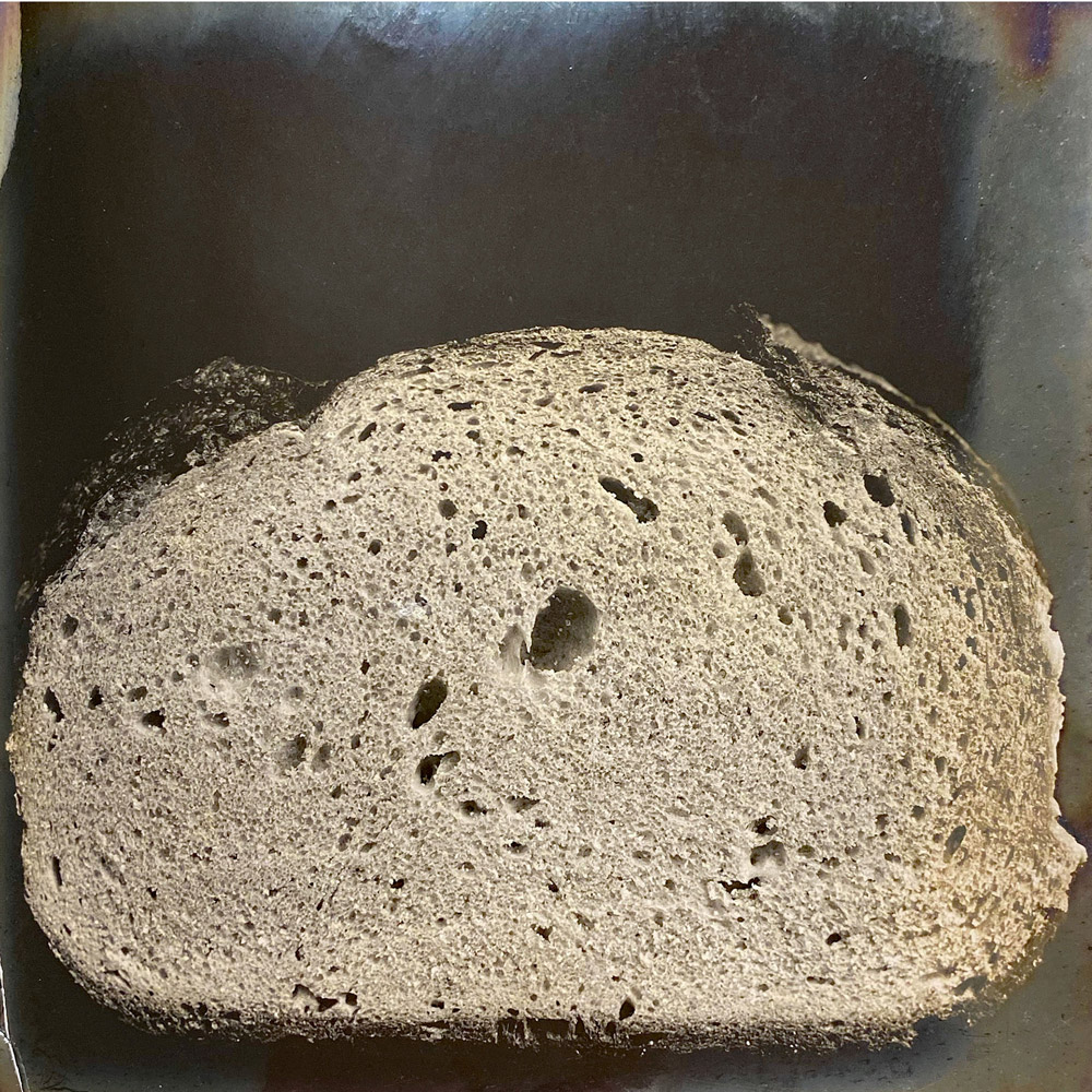 A photograph from Owen Simmons’s “The Book of Bread” depicting, according to the original caption, a section of “an English Coburg or Brunswick, selected as the best of its class in a recent competition. … In spite of the hole, which in a photograph is rendered exceedingly conspicuous.”