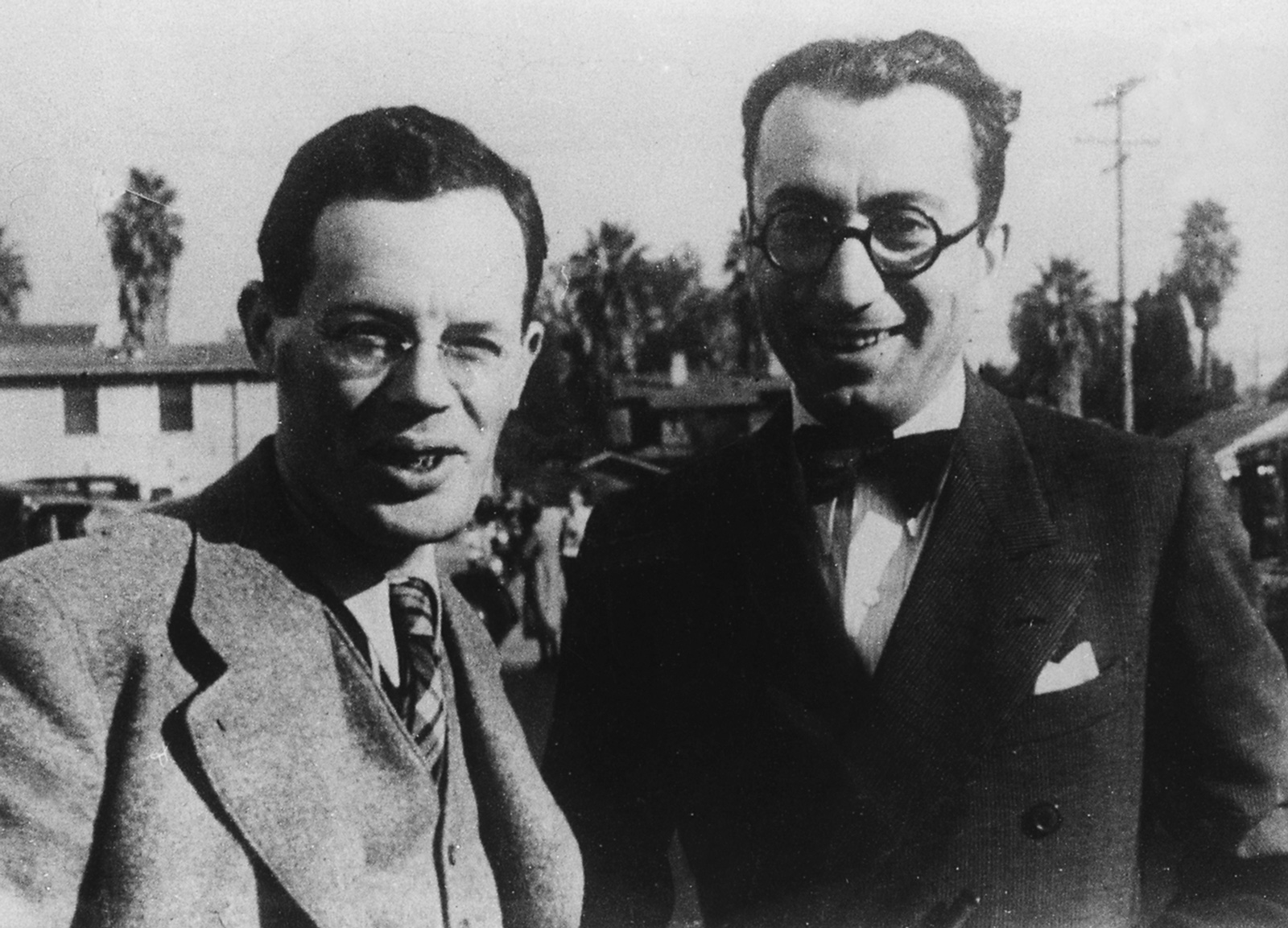 Photograph of Ilya Ilf and Evgeny Petrov standing in front of palm trees, nineteen thirty-five.