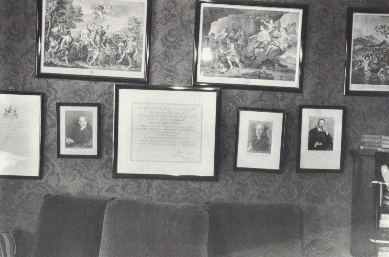 A photograph of various engravings and portraits in the waiting room of Freud’s practice.