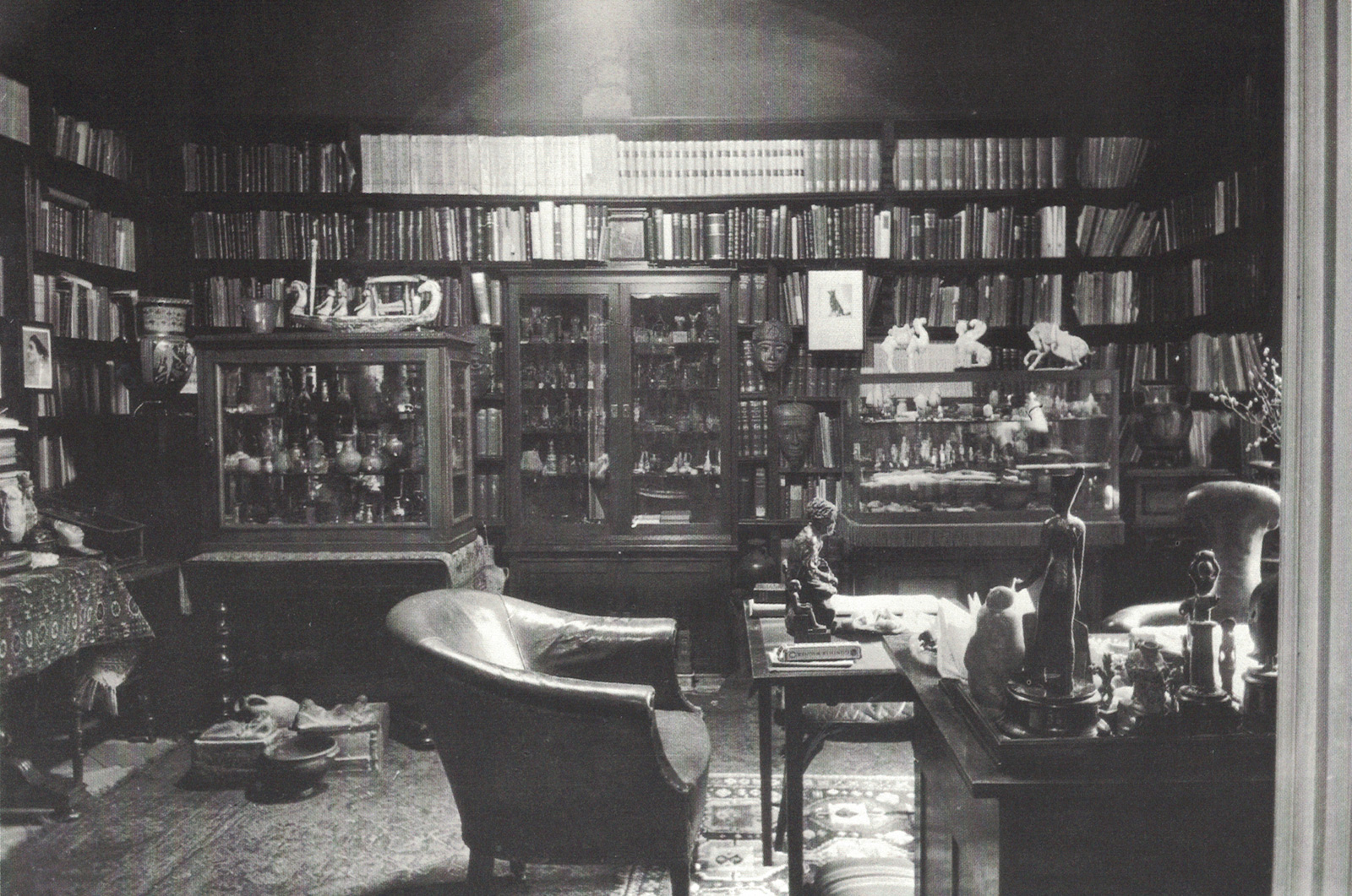 A photograph of Freud’s study, filled with shelves of books.