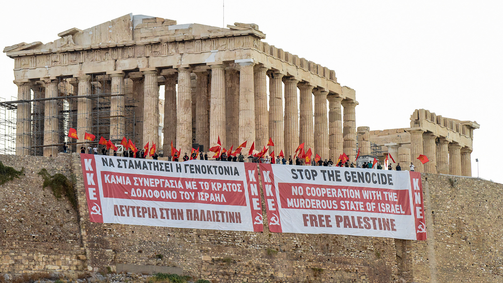 Political banners hung on a wall below the Acropolis in Athens.