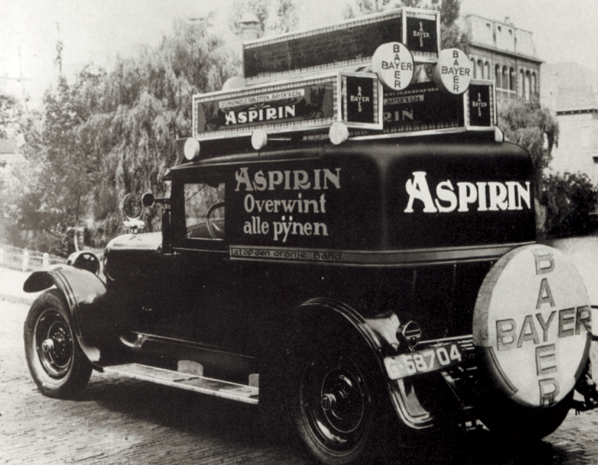 A photograph of an aspirin advertising truck, which became a familiar sight on European streets in the 1920s and 1930s, with the explosion of aspirin advertising.
