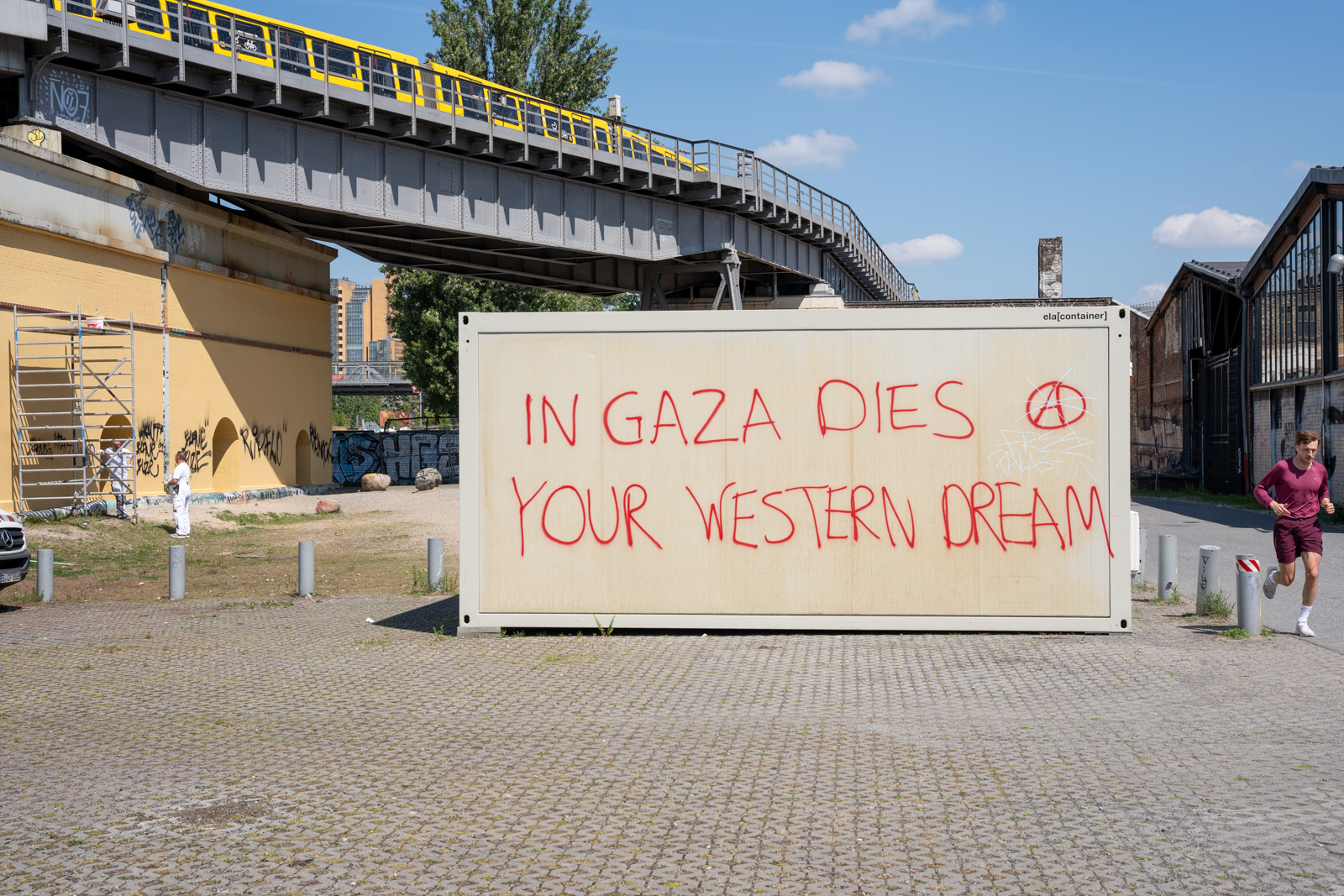 Spray-painted wall reading “In Gaza dies your Western dream.”